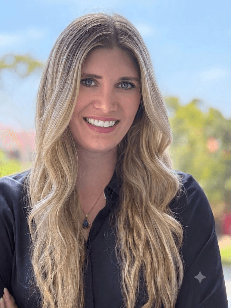 Portrait of Rebecca Share-Howard in a navy blazer, seated in a bright, calm office